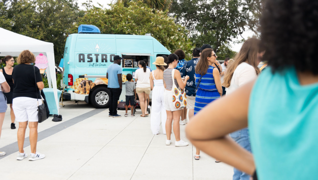 Line of people leading to an ice cream trucked called Astro